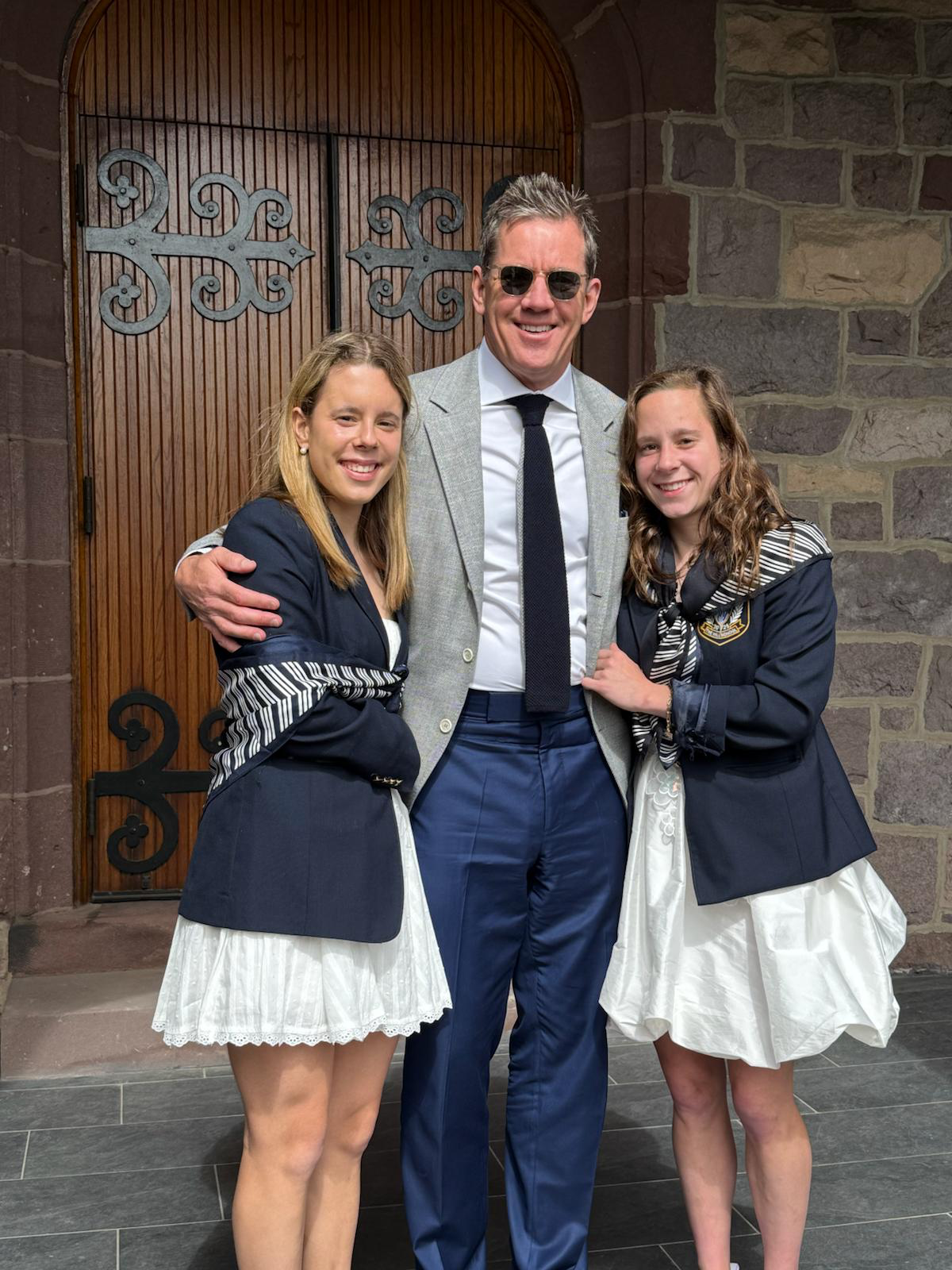 Daniel Leger with his daughters, Emerson and Finley, in front of an arched church door